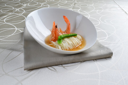 braised handmade thin noodle udon ramen with prawn and vegetable in premium stock soup in white background asian halal vegan menu