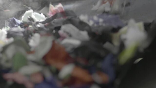 Closeup Shot Of Fabric Being Shredder In A Industrial Shredding Machine