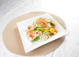 stir fried mixed vegetables with macadamia nut, green bean, lotus root, black fungus in white background asian halal vegan menu