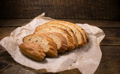 Pieces of rye bread on a wooden background.Rye bread cut into pieces located on a wooden table.