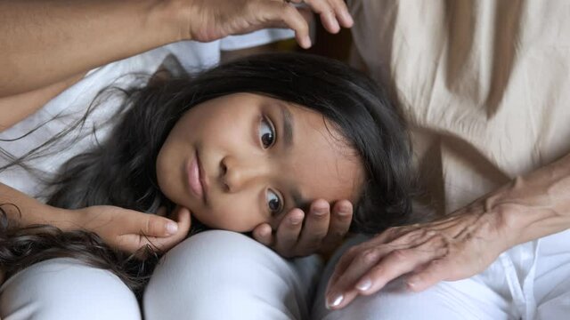 portrait of a beautiful girl lies on her lap with her mother and grandmother