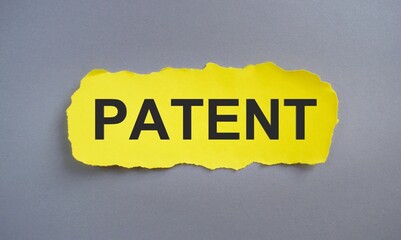 Patent word written on yellow torn paper, Business concept