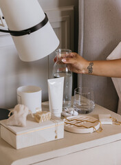 Woman's hand getting ready in the morning bedside table