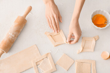 Woman preparing Danish pastry on kitchen table