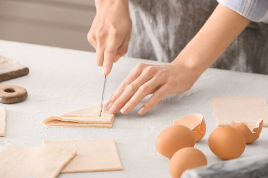 Woman preparing Danish pastry on kitchen table