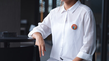 Closeup image of a woman with Covid-19 vaccinated sign brooch on shirt - obrazy, fototapety, plakaty