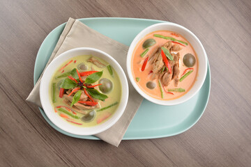 thai spicy chili red and green curry hot soup with vegetarian meat in bowl blue plate on wood background asian halal vegan menu