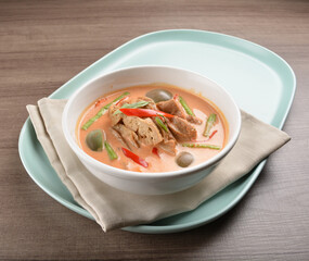 thai spicy chili red curry hot soup with vegetarian meat in bowl blue plate on wood background asian halal vegan menu