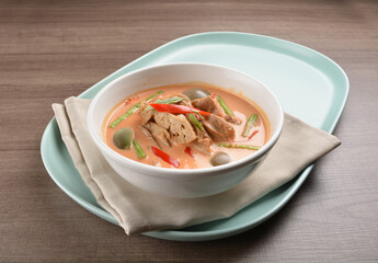 thai spicy chili red curry hot soup with vegetarian meat in bowl blue plate on wood background asian halal vegan menu