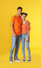 Obraz premium African-American brother and sister on color background