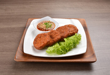 deep fried hash brown round potato cake with Thai spicy chilli sauce on wood background asian halal vegan menu