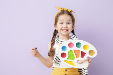 Cute little artist on color background