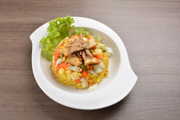 vegetarian nasi goreng fried rice with pineapple, vegetables meat in spicy chilli sambal sauce on wood background asian halal vegan menu