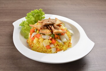 vegetarian nasi goreng fried rice with pineapple, vegetables meat in spicy chilli sambal sauce on wood background asian halal vegan menu