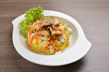 vegetarian nasi goreng fried rice with pineapple, vegetables meat in spicy chilli sambal sauce on wood background asian halal vegan menu