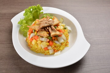 vegetarian nasi goreng fried rice with pineapple, vegetables meat in spicy chilli sambal sauce on wood background asian halal vegan menu