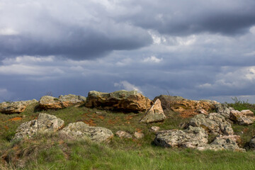 Bizarre boulders against the backdrop of heavy clouds