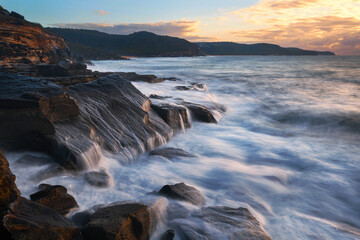 water flowing down the rocks along the coastline