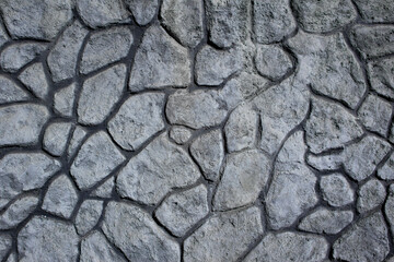 Wall of stones of different sizes and irregular shapes. Background. Texture.