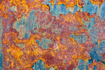 Paint and rust texture of orange, red, yellow and cyan colors. Industrial background.