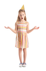 Surprised little girl in party hat on white background