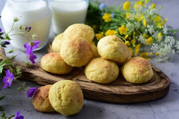Sweet dessert: delicious orange muffins for breakfast and a mug of milk on a gray background. Close-up