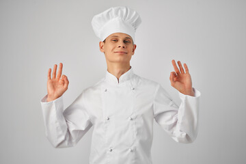 a man in a chef's uniform gesturing with a hand working in a restaurant professional