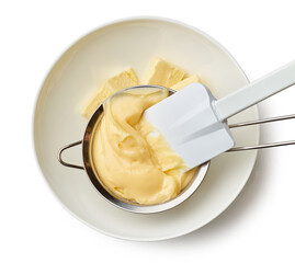 custard cream in a strainer