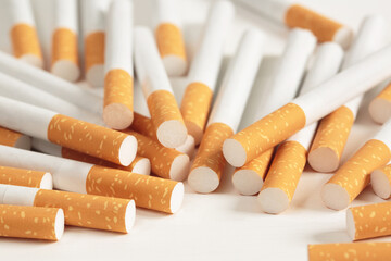 image of several commercially made pile cigarette on white  background. or Non smoking campaign concept, tobacco pattern top view.