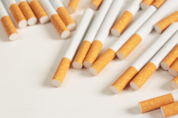 image of several commercially made pile cigarette on white  background. or Non smoking campaign concept, tobacco pattern top view.