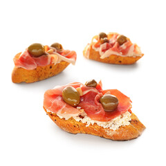 Tasty bruschettas with cheese, prosciutto and olives on white background