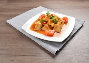 deep fried bean curd tofu with spicy sweet and sour chilli sauce on wood background asian halal vegan menu