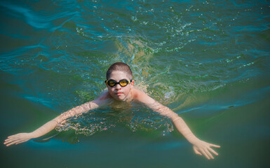 13 years Teenage boy swimming in lake, Children lifestyle. Enjoy the life