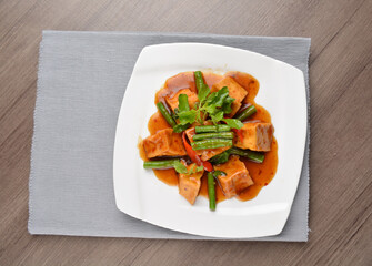 deep fried bean curd tofu with spicy sambal chilli sauce on wood background asian halal vegan menu