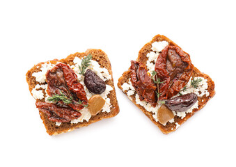 Tasty bruschettas with cheese, sun-dried tomatoes and dates on white background