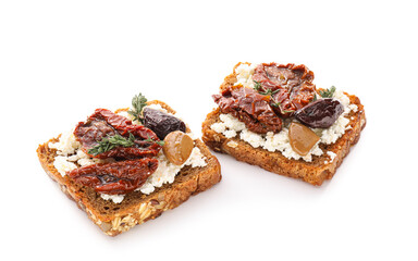 Tasty bruschettas with cheese, sun-dried tomatoes and dates on white background