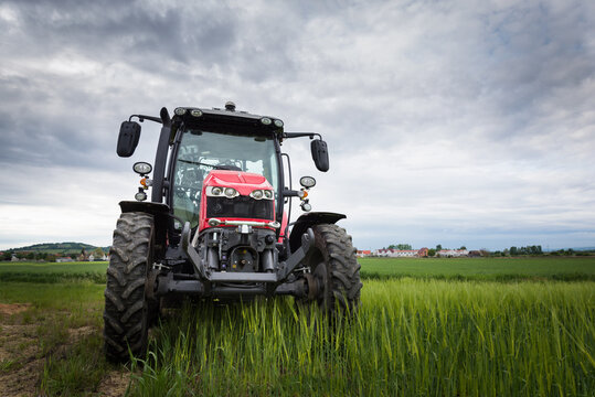 Tractor on a spring wheatfield