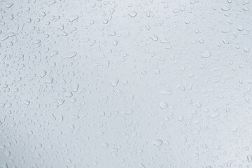 Rain drops and dew. water drops on a gray car roof after stopped raining , selective focus waterproof surface. soft focus. Leave space for writing text background.