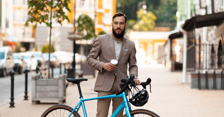 Ecological urban transport for one. Businessman in a suit with a bicycle on the street. Morning...