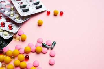 Fototapeta na wymiar pill packaging multicolored medicines pharmaceutical health pink background