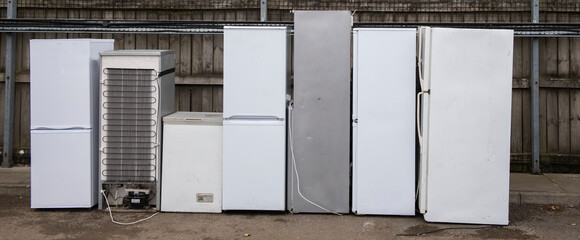 discarded fridges and freezers at a waste disposal site