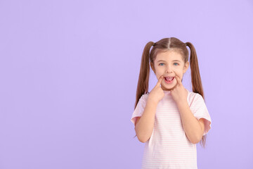 Obraz na płótnie Canvas Little girl training pronounce letters on color background