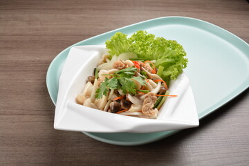 thai cold mushroom vegetable salad in spicy sour lime sauce on wood background asian halal vegan menu