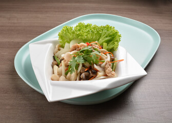 thai cold mushroom vegetable salad in spicy sour lime sauce on wood background asian halal vegan menu