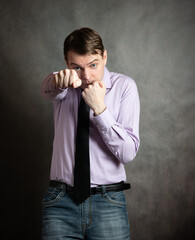 Portrait of angry young man on dark background.