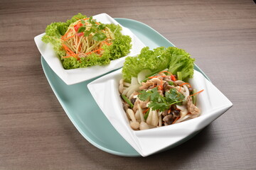 thai cold papaya mango and mushroom vegetable salad in spicy sour lime sauce on wood background asian halal vegan menu