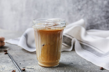 Glass of ice coffee with milk on grunge background