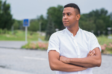 Obraz premium Portrait of a young African American man which arms crossed. Copy space