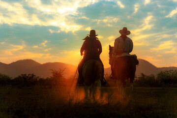 Cowboy silhouette riding a horse When the sunset looks beautiful
