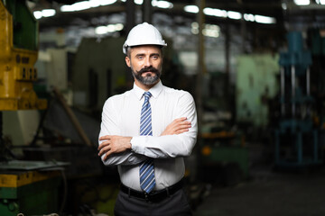 Man at work. Mechanical Engineer Bearded man in Hard Hat  in Heavy Industry Manufacturing Facility. Professional Engineer Operating lathe Machinery